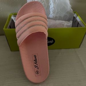 A pair of platform slide sandals